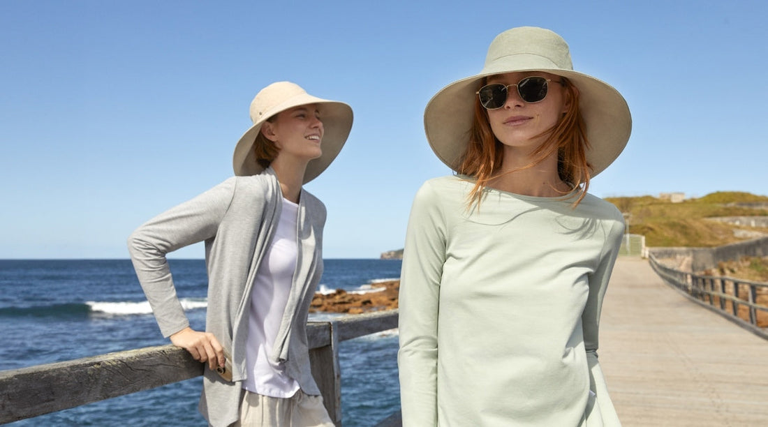 Two women wearing sun smart clothing and sun hats