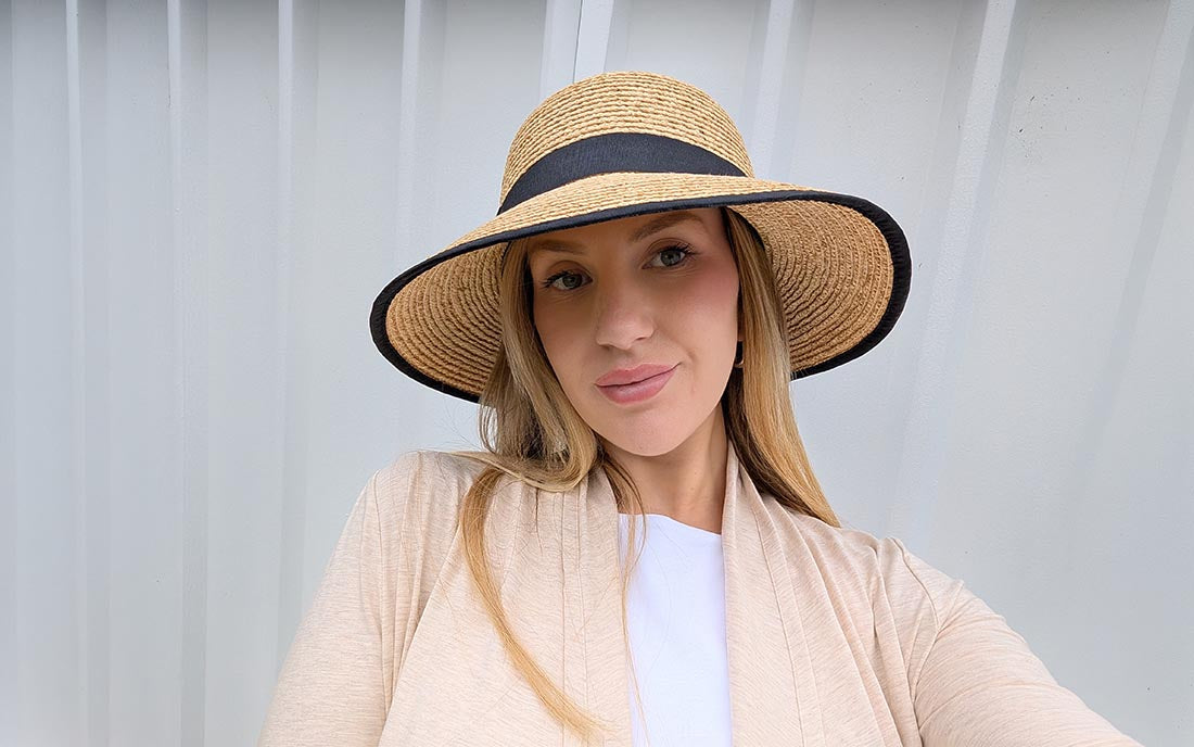 Courtney wears a Solbari sun hat and Luxe Sun Wrap