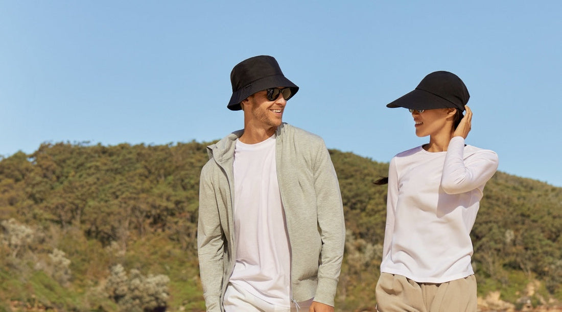 A man and a woman wearing black sun hats.