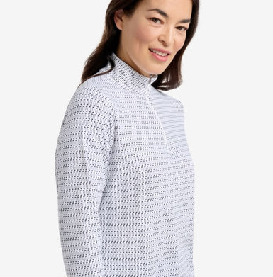 Woman wearing a textured white and gray long-sleeve shirt on a light gray background
