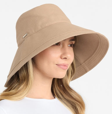 Woman wearing a beige bucket hat on a white background